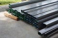 StackÃ¢â¬â¹ of rectangular metal pipes forÃ¢â¬â¹ constructionÃ¢â¬â¹ suppliesÃ¢â¬â¹ Royalty Free Stock Photo